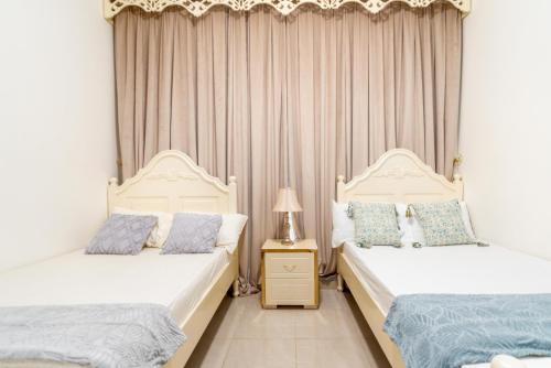 two beds sitting next to each other in a bedroom at sand and beach haven at Ajman Corniche! in Dubai