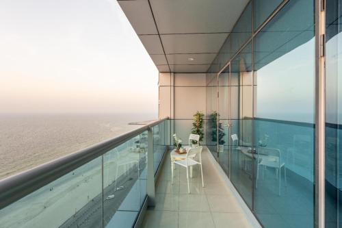 a view of the ocean from the balcony of a building at sand and beach haven at Ajman Corniche! in Dubai