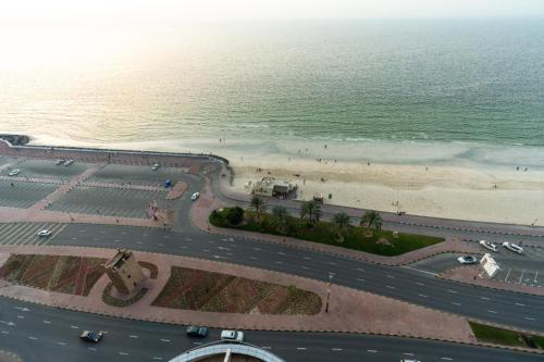 an aerial view of a road next to the beach at sand and beach haven at Ajman Corniche! in Dubai