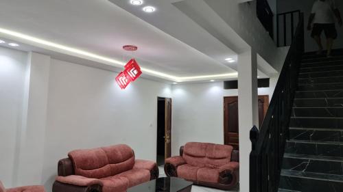 two chairs in a waiting room with a exit sign at Villa Mbine-Diene in Mbodiène