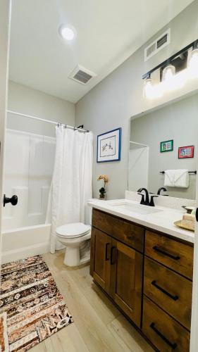 a bathroom with a sink and a toilet and a tub at Luxury Comfort Near Downtown in Idaho Falls