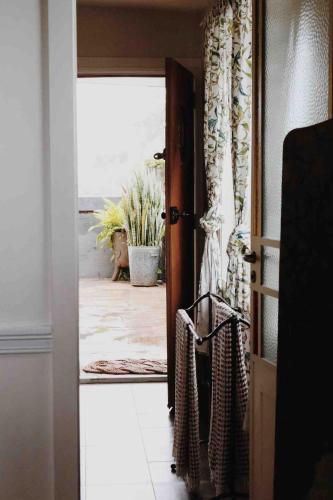 an open door to a room with a plant at Two Swans in Brunswick Heads