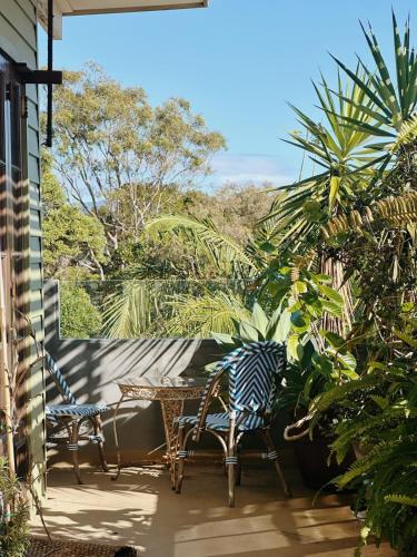 a patio with two chairs and a table at Two Swans in Brunswick Heads