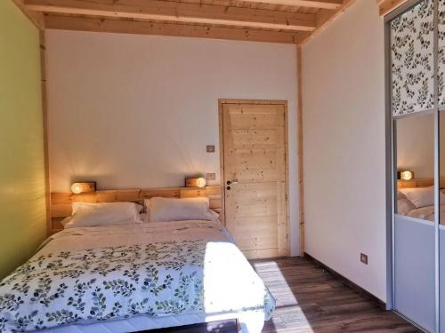 a bedroom with a large bed in a room at Grand gîte rénové, billard, baby-foot, vue sur rivière, terrasse, activités diverses - FR-1-582-76 in Le Chambon-sur-Lignon