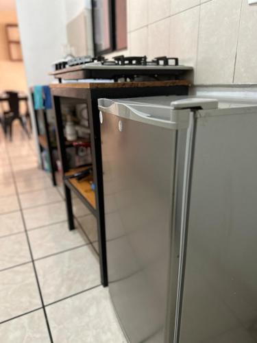 a kitchen with a stainless steel refrigerator and a counter at Casa completa para descansar entre zona industrial y zona centro in Gómez