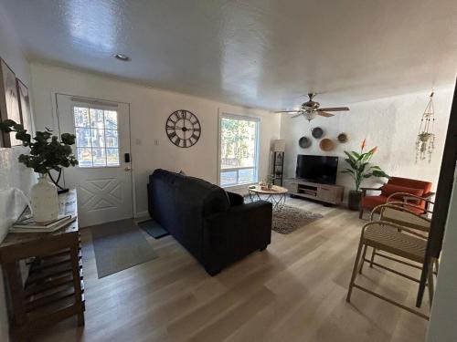 a living room with a couch and a clock on the wall at COH0957 - Bella Ari home in South Lake Tahoe