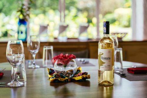 a bottle of wine sitting on a table with glasses at Enchanted Galapagos Lodge in Puerto Ayora