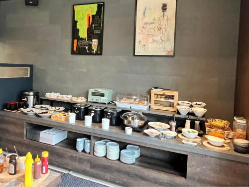 a buffet line with plates and bowls of food at Park Hotel Kyoto in Kyoto