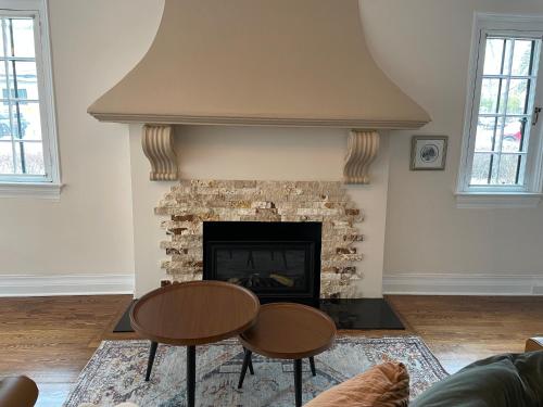 a living room with a table and a fireplace at The Ambassador in Ottawa