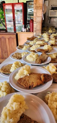 a row of plates of food on a table at Terra Iguazú Cabañas in Puerto Iguazú