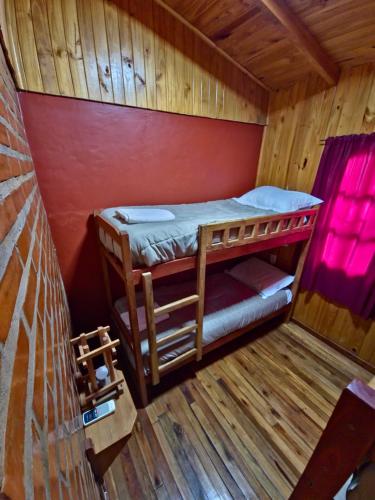 a room with two bunk beds in a cabin at Terra Iguazú Cabañas in Puerto Iguazú