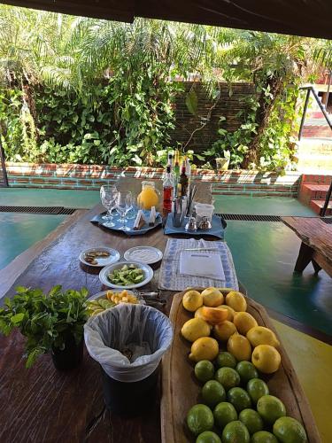 a wooden table with fruits and vegetables on it at Terra Iguazú Cabañas in Puerto Iguazú