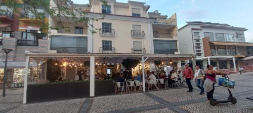 a group of people walking in front of a building at Golden House in Fátima