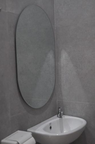 a bathroom with a sink and a mirror on the wall at Lily house kedungu in Tabanan