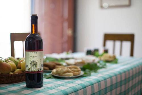 a bottle of wine sitting on top of a table at Agriturismo Miracco Atanasio Franco "Il Maniero" in Santa Sofia dʼEpiro