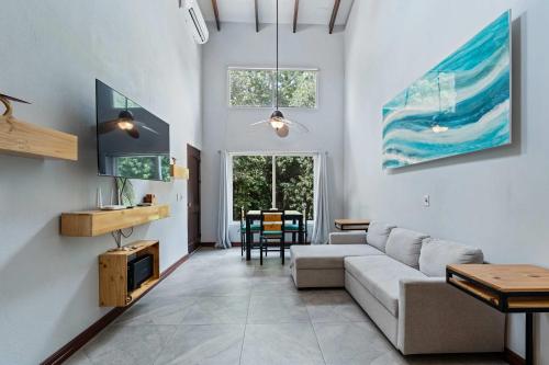 a living room with a couch and a table at Beach walkable loft condo with pool in Potrero