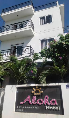 a hotel sign in front of a building at Aloha Hotel Mũi Né in Ấp Thiện Sơn