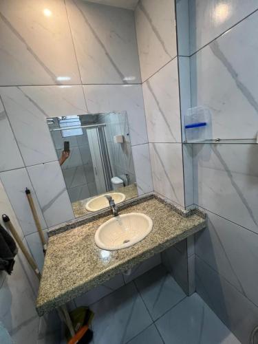 a bathroom with a sink and a mirror at Residencial JC II sua casa em Belém do Pará in Belém