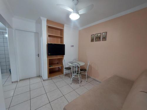 a living room with a table and a television at diRoma Fiori - Apartamentos JN in Caldas Novas