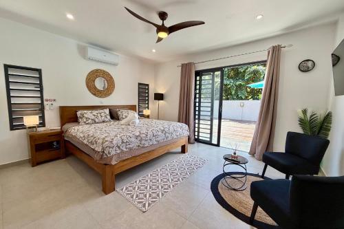 a bedroom with a bed and a ceiling fan at Villa Moea private pool confort & serenity in Pirae - AC- Wifi - 3 bdr in Pirae