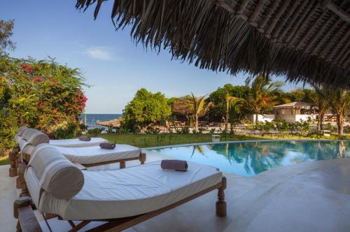 a resort with two beds and a swimming pool at The Kasa Malindi in Malindi