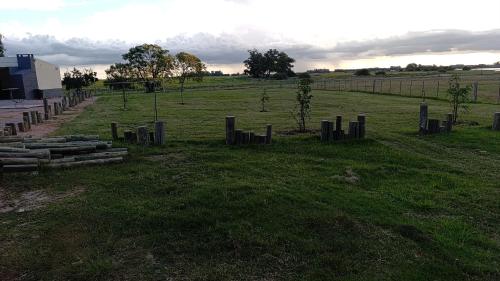 a cemetery in a field with trees and a fence at La Martinna 3 in Trinidad
