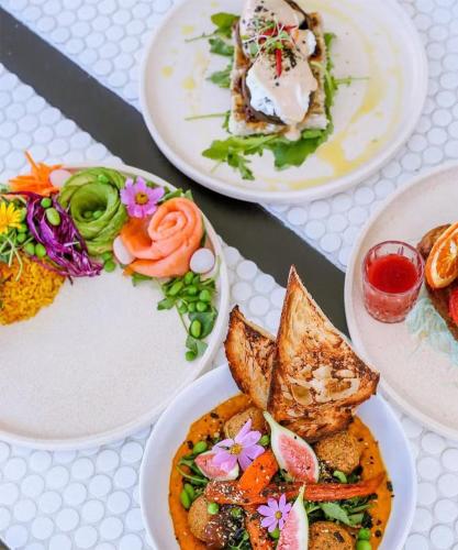 a group of plates of food on a table at HEART OF Cotton Tree, Maroochydore BEACH & RIVER in Maroochydore