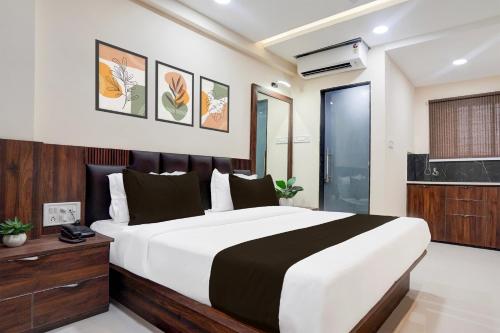 a bedroom with a large bed in a room at Hotel O Lakshya in Indore