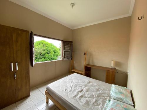 Ένα ή περισσότερα κρεβάτια σε δωμάτιο στο Quintal de Casa
