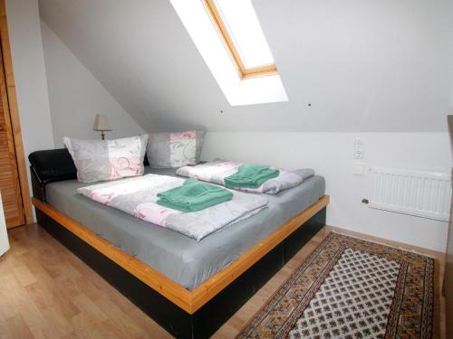 a bed with two green towels on it in a room at Apartment für 3 in Metelsdorf in Metelsdorf