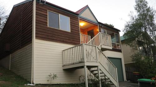 a house with a staircase on the side of it at Mountain Views Cedar Cottage in Blackheath