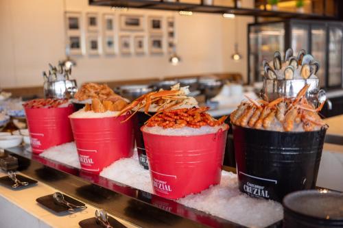 a group of buckets of food on a counter at 青岛海天大酒店 山海相拥典雅奢华 in Qingdao