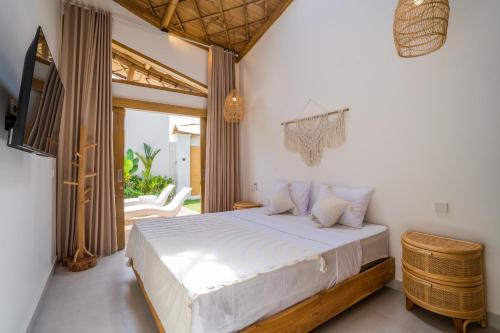 a bedroom with a large bed and a balcony at M&M Dream Villa - 2 BR Villa in Kerobokan in Kerobokan