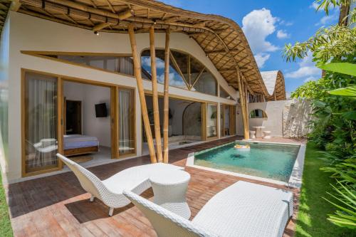 an external view of a villa with a swimming pool at M&M Dream Villa - 2 BR Villa in Kerobokan in Kerobokan