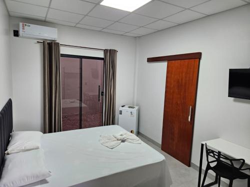 En eller flere senge i et værelse på Oriente Hotel