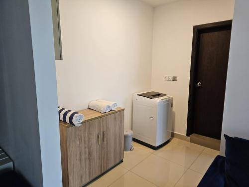 a bathroom with a washer and dryer in a room at Ocean Breeze Sea View Luxury Apartments in Negombo