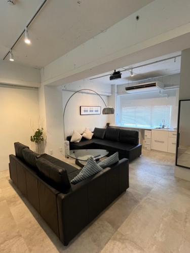 a living room with a couch and a table at GalleryInn Fuji, Shibuya in Tokyo