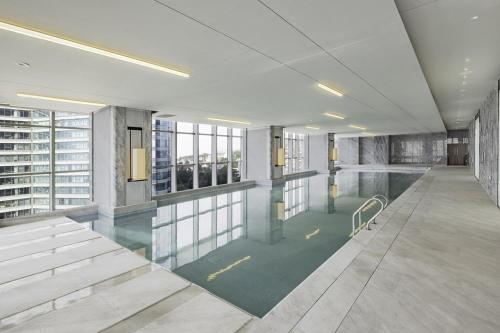 a lobby with a swimming pool in a building at 青岛海天大酒店 山海相拥典雅奢华 in Qingdao