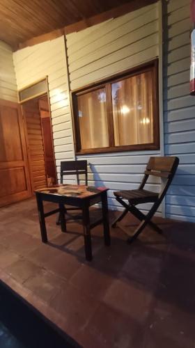 a table and a chair sitting on a porch at Villa Atitlan in Panajachel