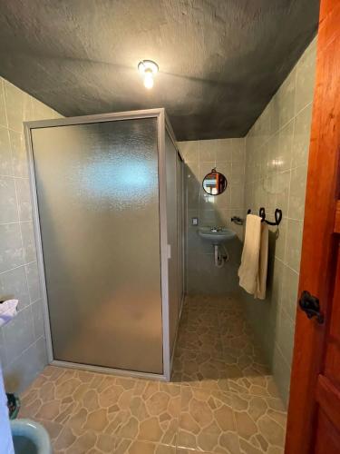 a shower with a glass door in a bathroom at La Casa del Abuelito in San Miguel Regla