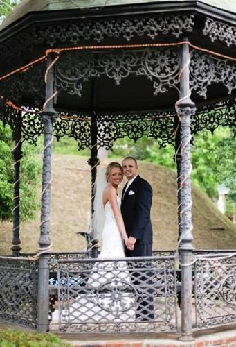 a bride and groom standing in a gazebo at The Inn at Cedar Grove in Vicksburg