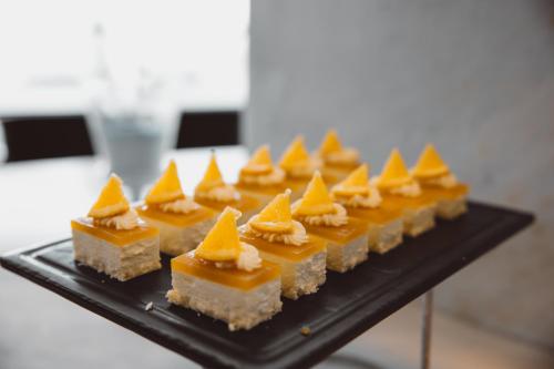 a black plate topped with different types of desserts at 青岛海天大酒店 山海相拥典雅奢华 in Qingdao