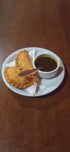 a plate of food with chips and a bowl of soup at Terra Iguazú Cabañas in Puerto Iguazú