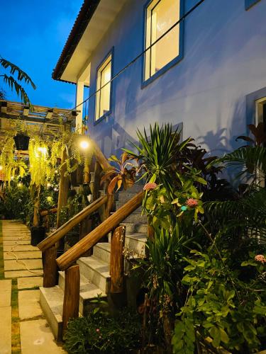 a house with stairs and plants in front of it at Moloppor Villa in Battambang