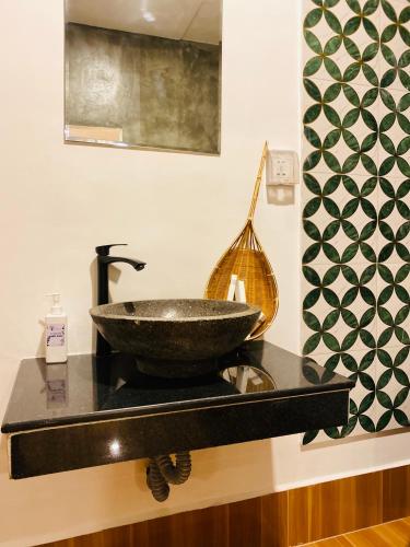 a bathroom with a sink on a counter at Moloppor Villa in Battambang