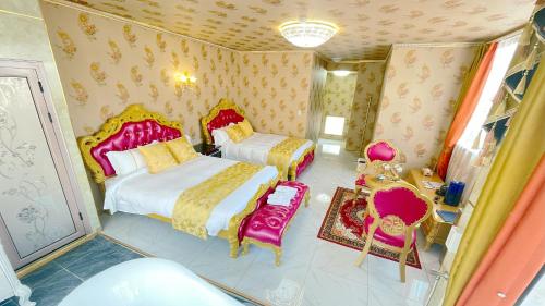 a bedroom with two beds and two chairs in it at ホテル　ロモサ in Minakami