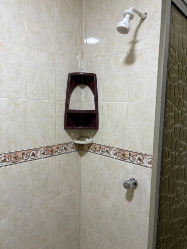 a bathroom with a shower with a soap dispenser at Apartamentos KARS in Ríohacha
