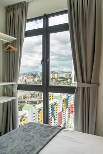 a bedroom with a window with a view of a city at Neu Suites KL with Daily Breakfast Included in Kuala Lumpur