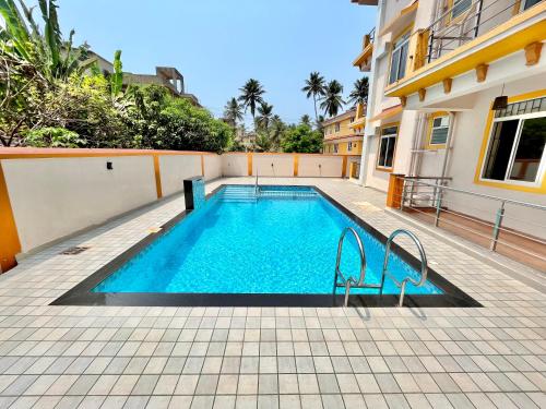 a swimming pool in the middle of a building at Lykke Suites- 2-min Drive to Colva Beach-By Goan Felicidade Hospitality PVT LTD in Colva