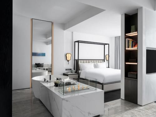 a hotel room with a bed and a glass counter at FU VALLEY Hotel in Liyang
